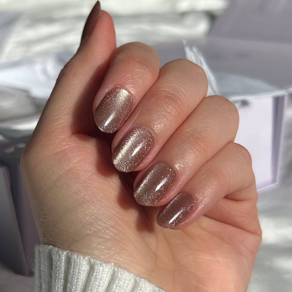 brown glitter press on nails in the sun close up photo