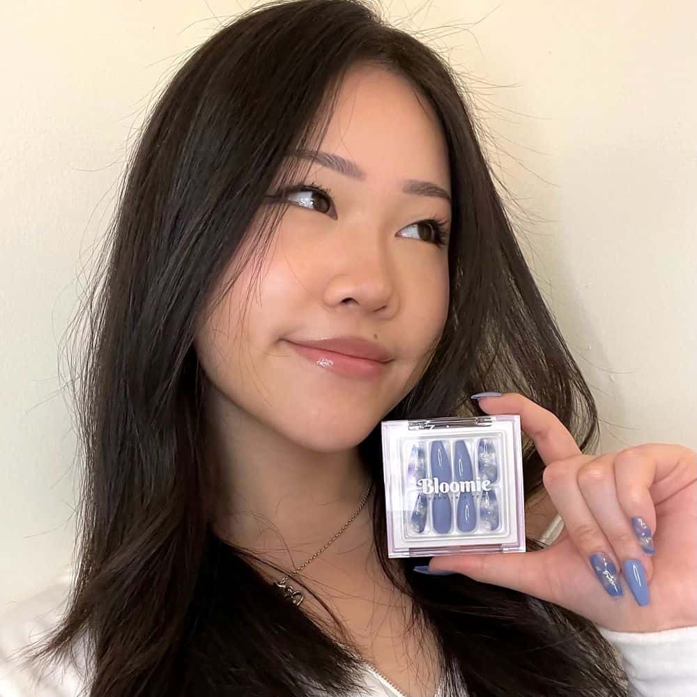 female model wearing blue cloud nails