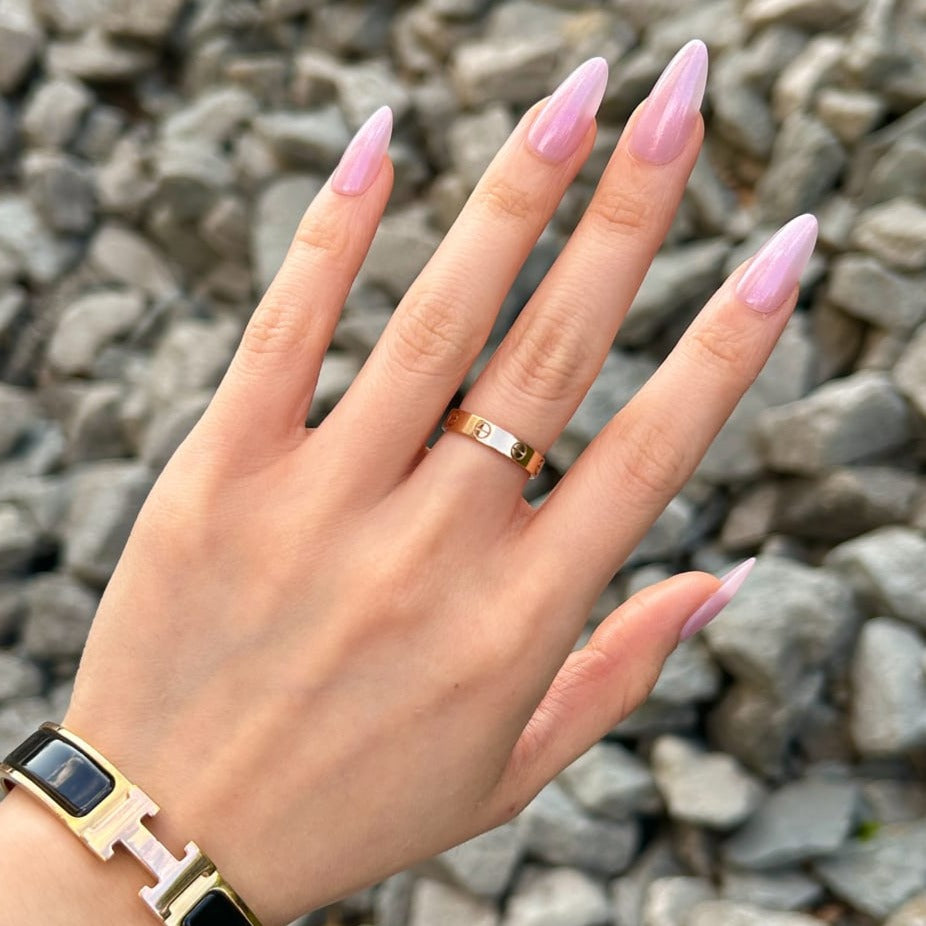 female hand wearing pink glazed donut press on nails