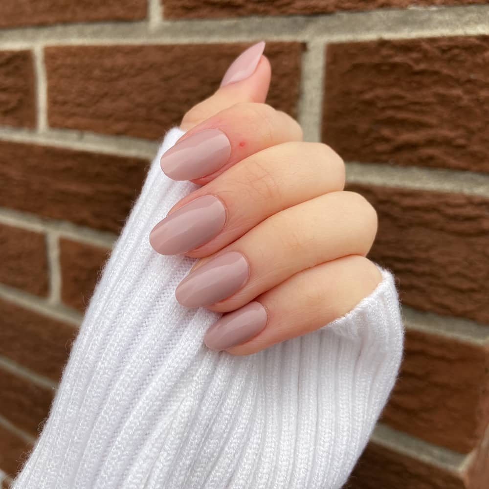 pink nude nails press ons worn by female model