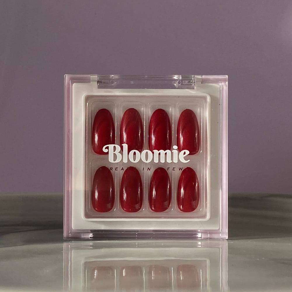 close-up-almond-shaped- dark-red-press-on -nails-in-box