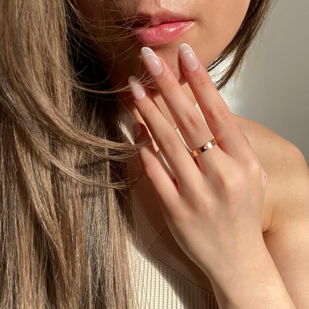 girl-wearing-double-french-press-on-nails-during-golden-hour-candid-photo