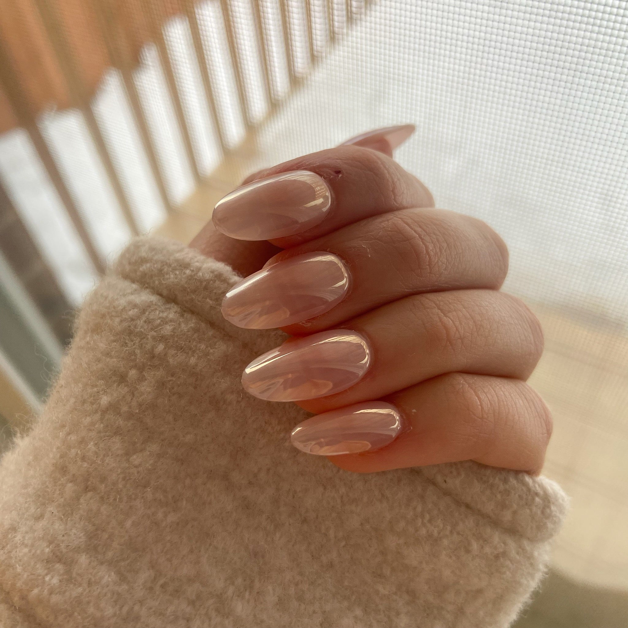 pink-glazed-donut-press-on-nails-worn-on-hand
